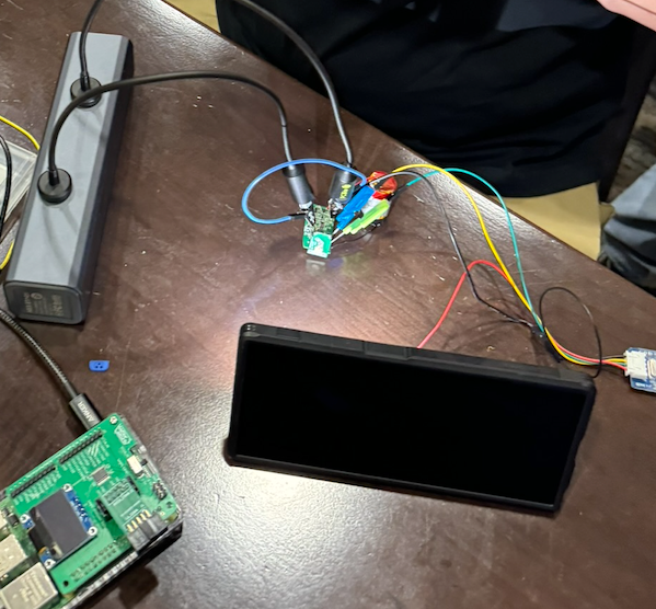 Precarious PCBite probes and hooks attempting to provide a connection to a debugger.
